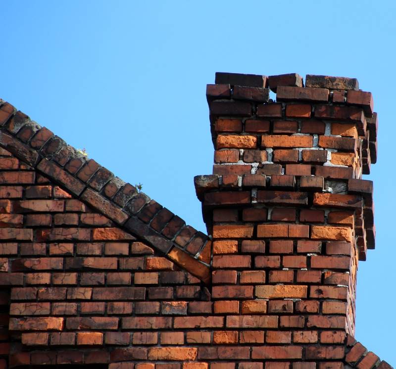 Damaged chimney on an Los Altos home showing cracks and missing mortar